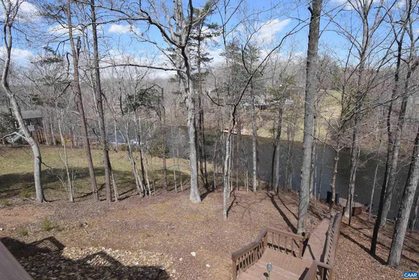 a view of a backyard with wooden fence