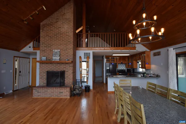 a view of a livingroom with furniture wooden floor and a fireplace