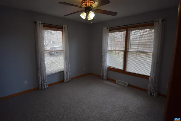 an empty room with windows and closet