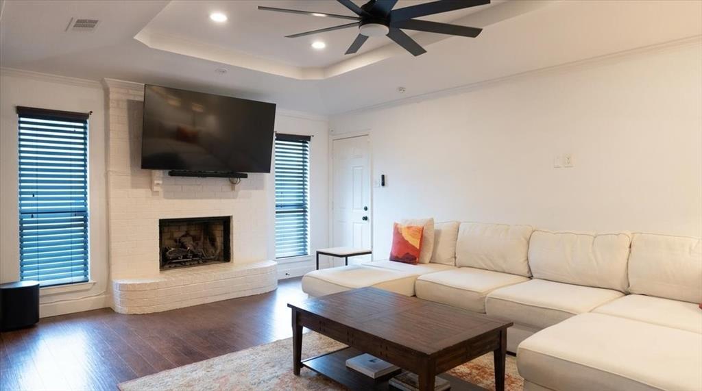 504 Bluebird Lane Red Oak, TX 75154 - Photo 11 of 28 a living room with furniture a flat screen tv and a fireplace
