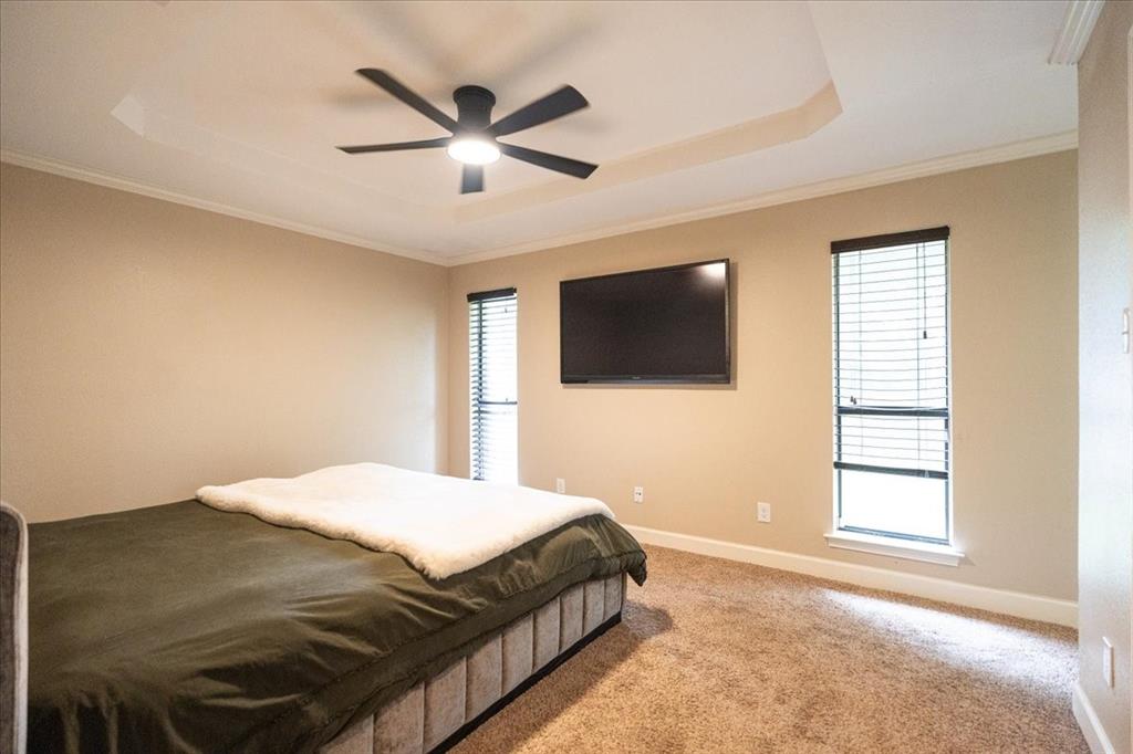 504 Bluebird Lane Red Oak, TX 75154 - Photo 14 of 28 a bedroom with a bed a flat screen tv and a window
