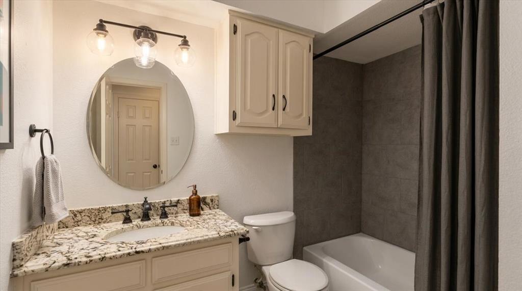 504 Bluebird Lane Red Oak, TX 75154 - Photo 16 of 28 a bathroom with a granite countertop sink toilet and a mirror