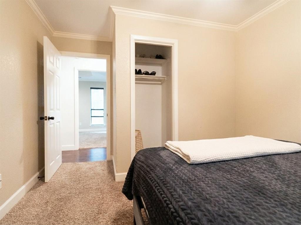 504 Bluebird Lane Red Oak, TX 75154 - Photo 18 of 28 a bedroom with a bed and a table