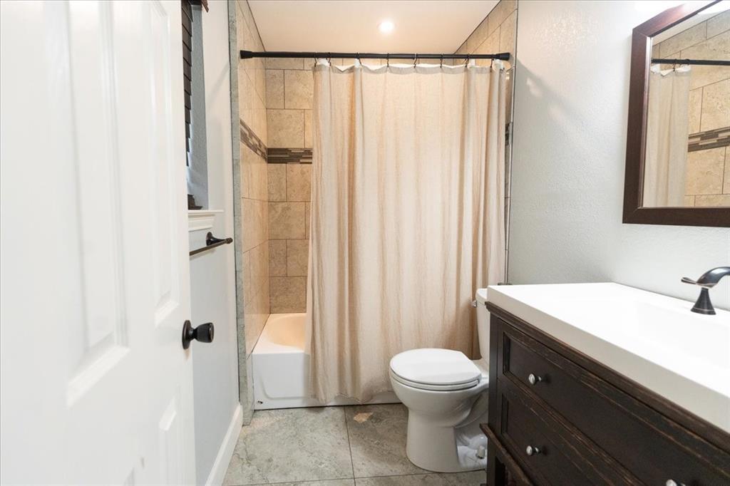 504 Bluebird Lane Red Oak, TX 75154 - Photo 19 of 28 a bathroom with a sink a toilet and shower