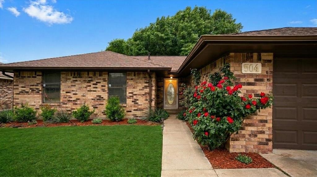 504 Bluebird Lane Red Oak, TX 75154 - Photo 2 of 28 a view of a pathway that has flowers on it
