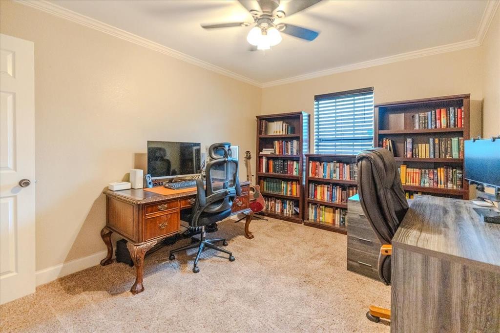 504 Bluebird Lane Red Oak, TX 75154 - Photo 21 of 28 a view of a workspace with furniture and a bookshelf