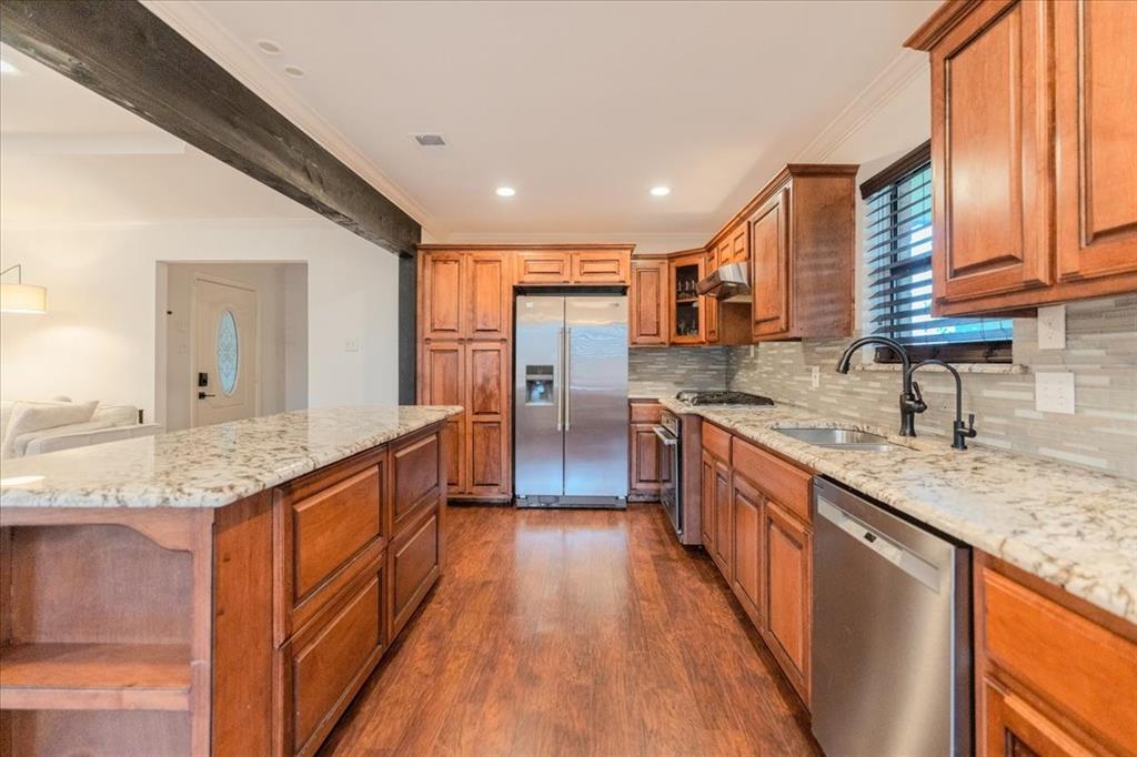 504 Bluebird Lane Red Oak, TX 75154 - Photo 5 of 28 a large kitchen with stainless steel appliances granite countertop a lot of counter space and wooden floors