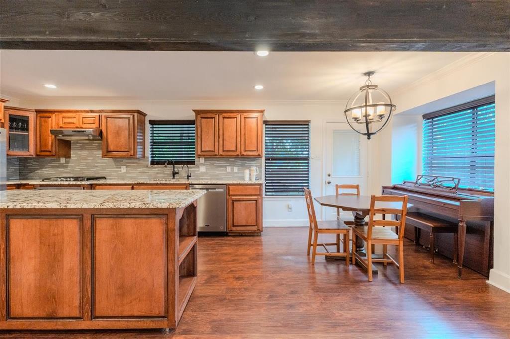 504 Bluebird Lane Red Oak, TX 75154 - Photo 6 of 28 a kitchen with stainless steel appliances granite countertop a sink wooden cabinets and granite counter tops