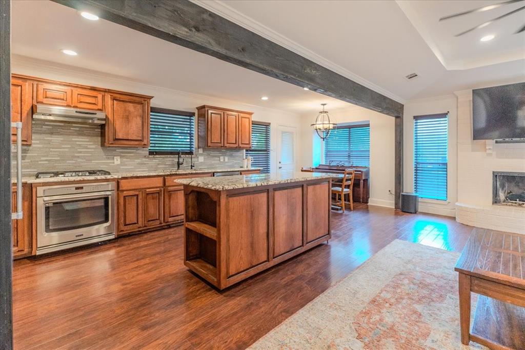 504 Bluebird Lane Red Oak, TX 75154 - Photo 7 of 28 a kitchen with stainless steel appliances granite countertop a stove a sink and a microwave