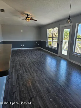 a view of a kitchen with wooden floor and a kitchen space