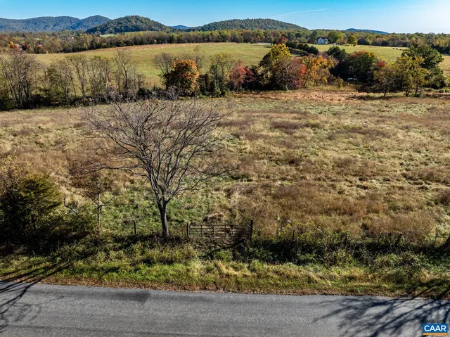 a view of yard covered with snow in front of house
