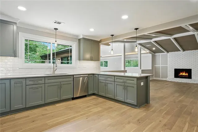 a kitchen with a sink window and cabinets