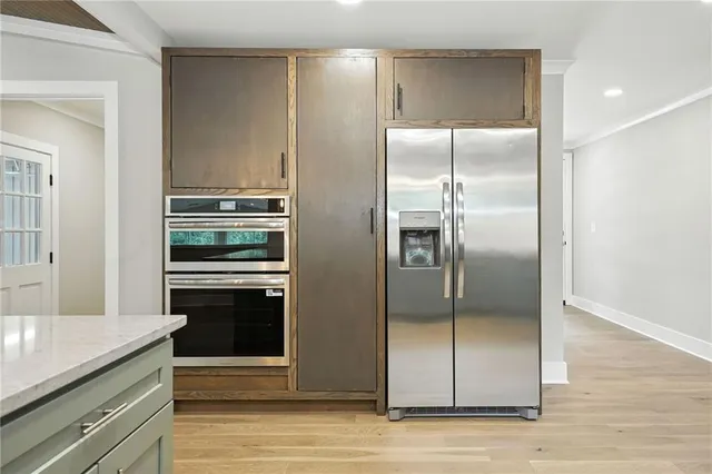 a kitchen with a refrigerator and a counter space