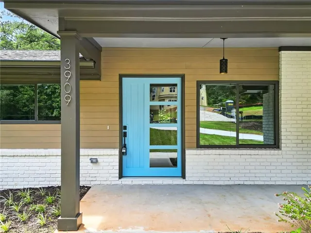 a front view of a house with a garden