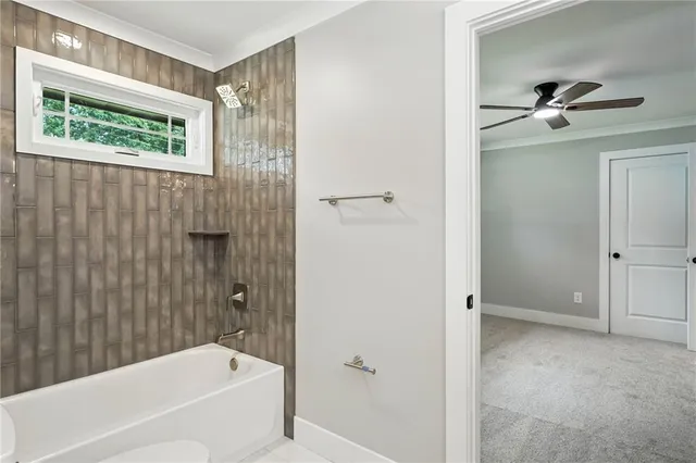 a bathroom with a bathtub and shower