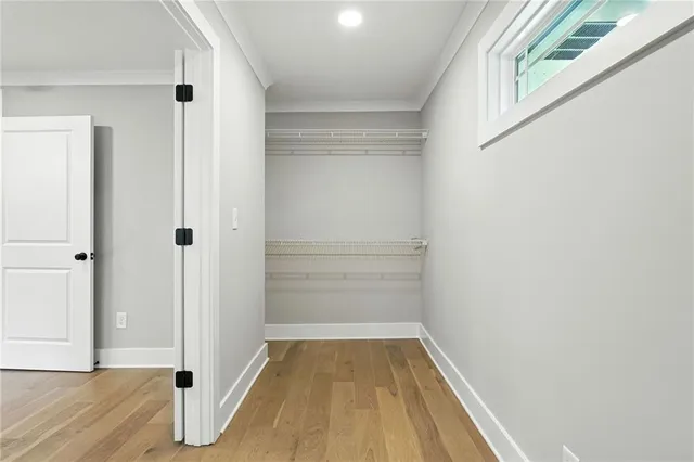 a view of a small space with wooden floor and closet