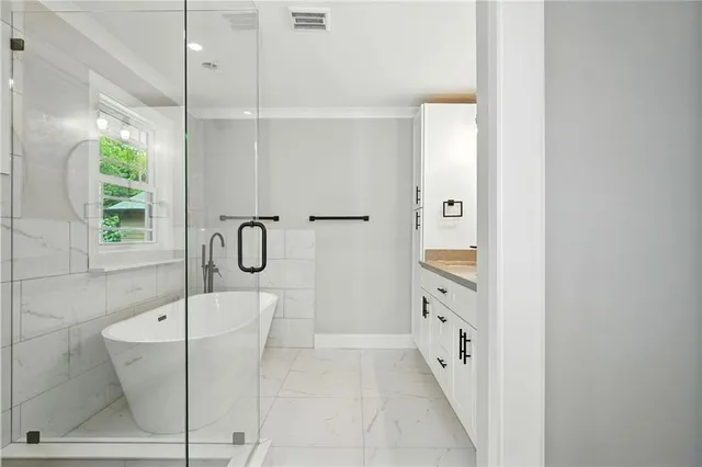 a bathroom with a bathtub and a shower