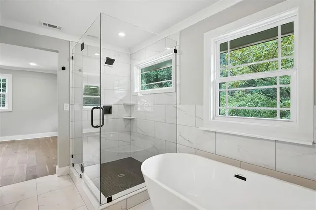 a bathroom with a tub and a shower