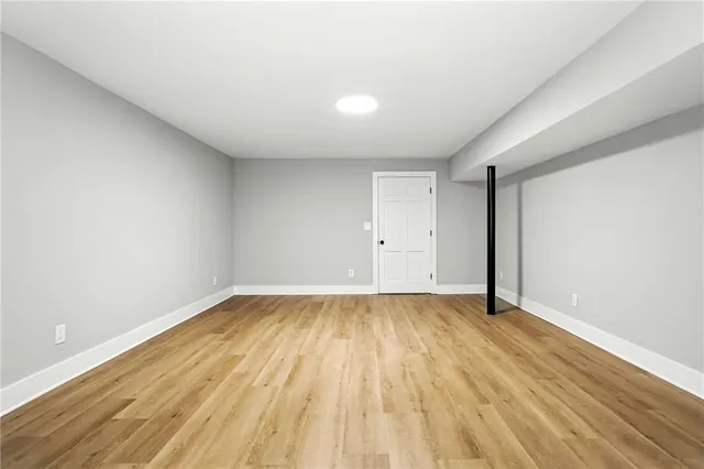 a view of an empty room and wooden floor