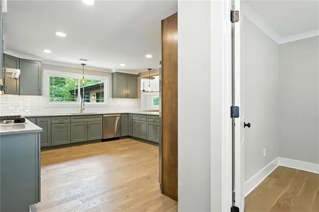 a kitchen with kitchen island a sink appliances and cabinets