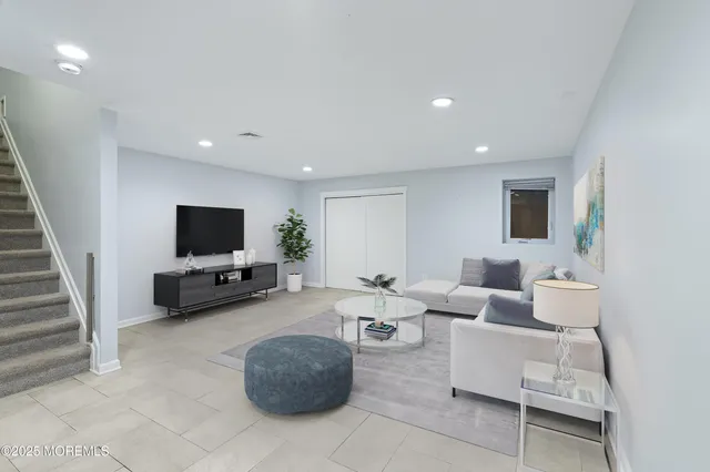 a living room with furniture and a wall painting