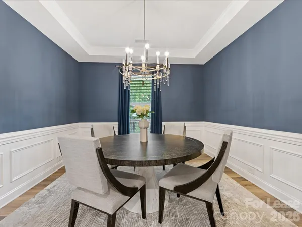a view of a dining room with furniture and chandelier