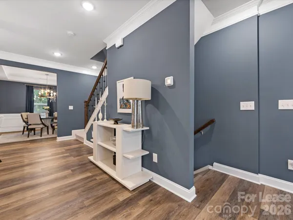 a view of entryway and hall with wooden floor