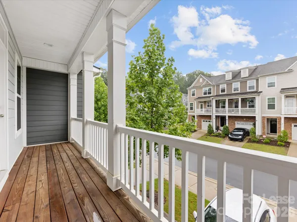 a balcony with wooden floor and fence