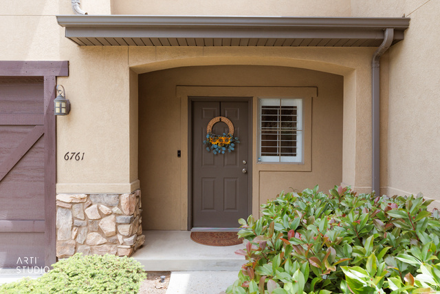 6761 950 East Midvale, UT 84047 - Photo 3 of 44 Entryway featuring a covered porch, stone accent siding, and stucco exterior
