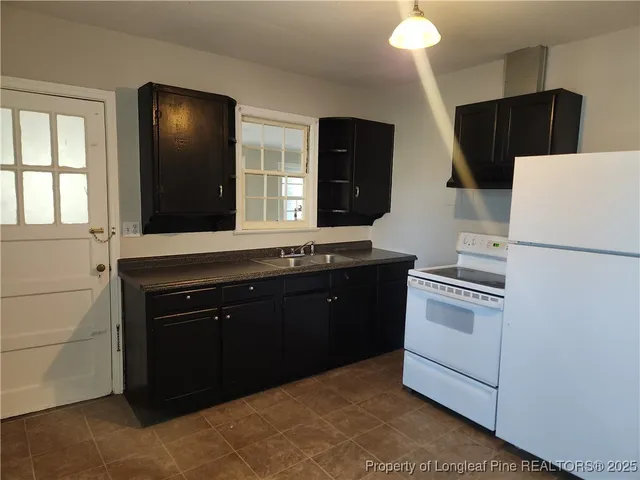 a kitchen with a sink and a refrigerator