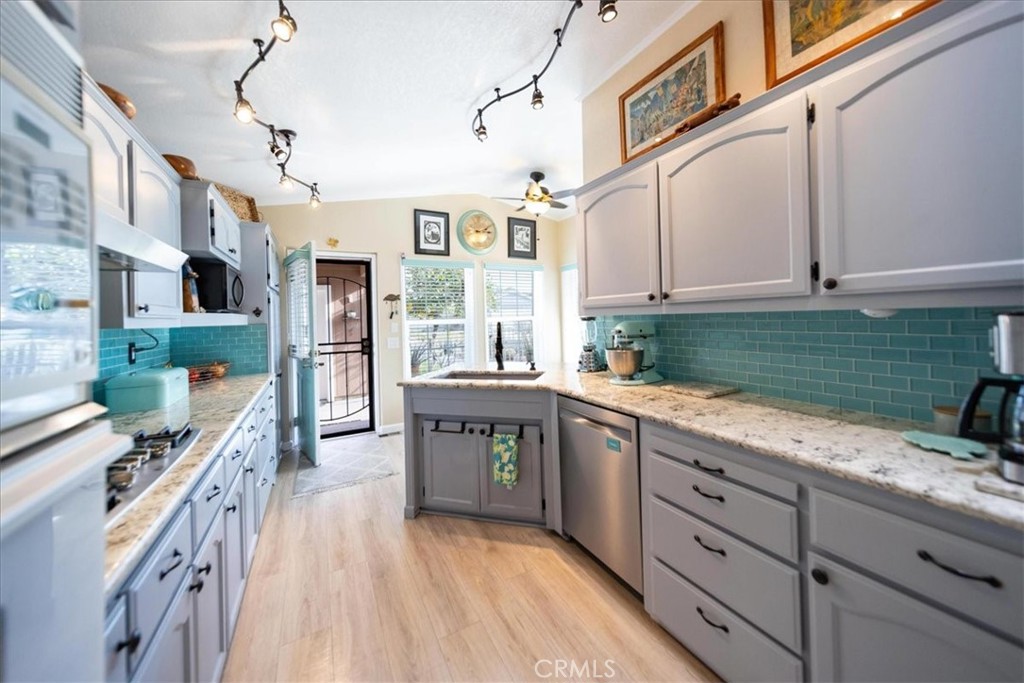 35493 Sand Rock Road Thousand Palms, CA 92276 - Photo 15 of 71 a kitchen with stainless steel appliances granite countertop a lot of counter space and wooden floors