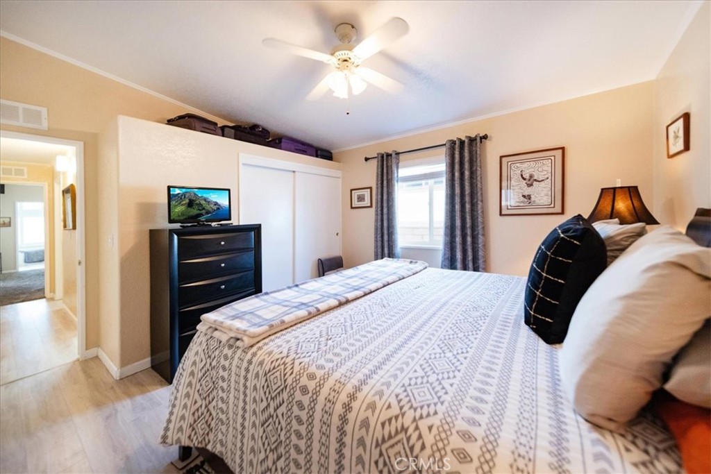 35493 Sand Rock Road Thousand Palms, CA 92276 - Photo 21 of 71 a bedroom with a bed and a chandelier