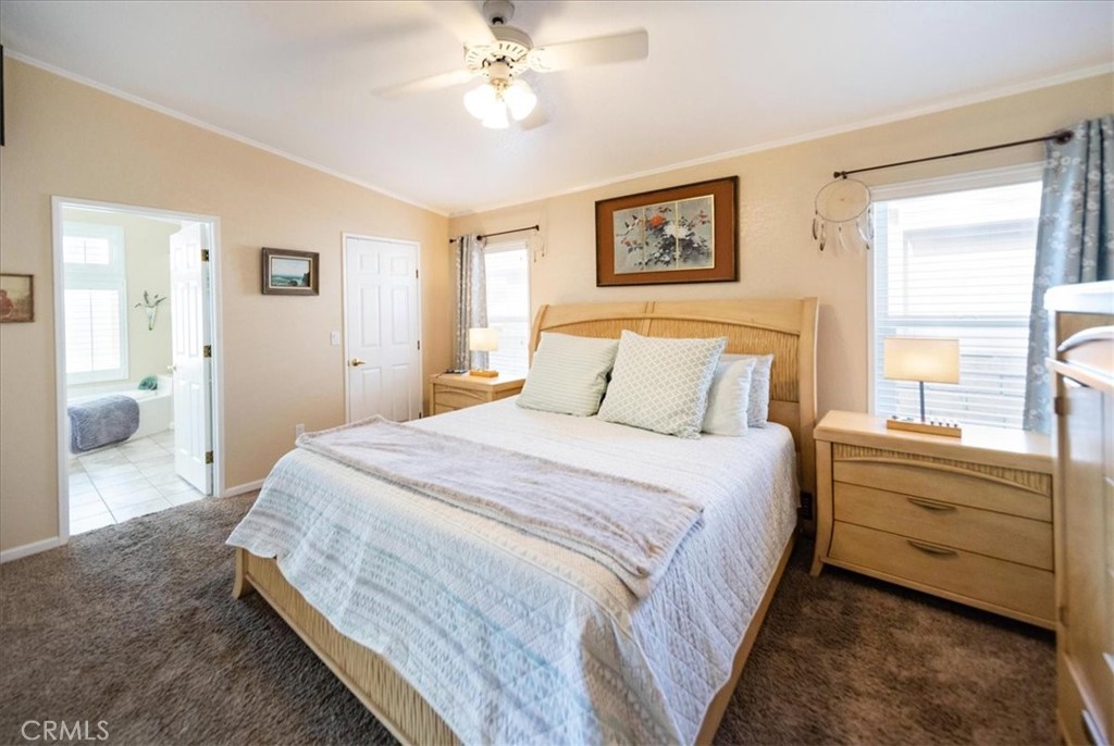 35493 Sand Rock Road Thousand Palms, CA 92276 - Photo 22 of 71 a bedroom with a bed and a chandelier