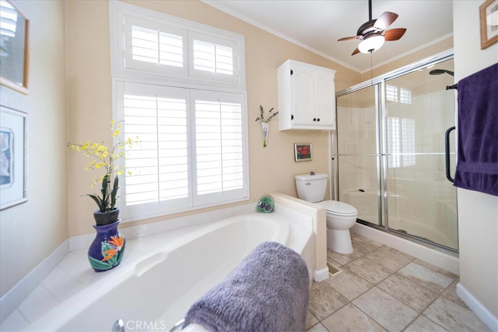 35493 Sand Rock Road Thousand Palms, CA 92276 - Photo 27 of 71 a spacious bathroom with a tub shower and a window