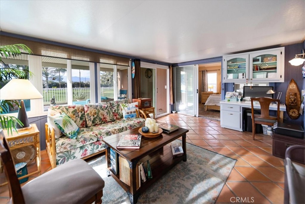 35493 Sand Rock Road Thousand Palms, CA 92276 - Photo 28 of 71 a living room with furniture and large windows
