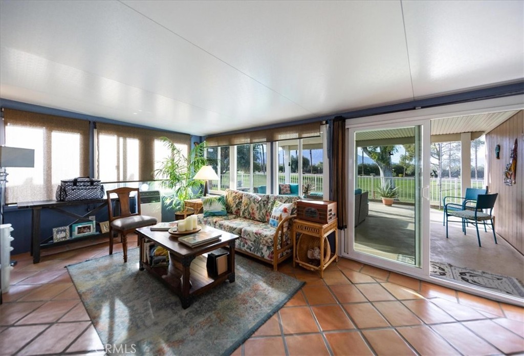 35493 Sand Rock Road Thousand Palms, CA 92276 - Photo 29 of 71 a living room with furniture and large windows