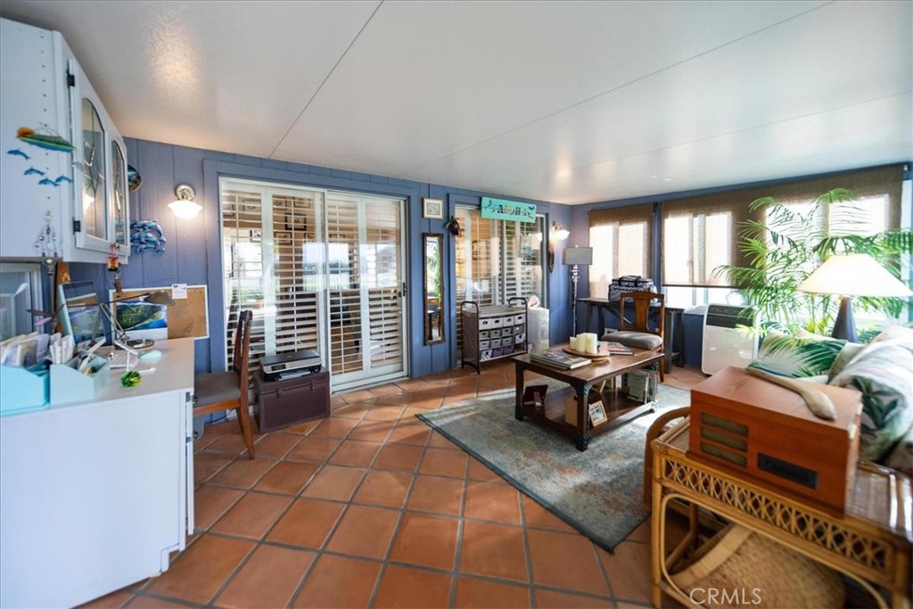 35493 Sand Rock Road Thousand Palms, CA 92276 - Photo 30 of 71 a living room with furniture and a floor to ceiling window
