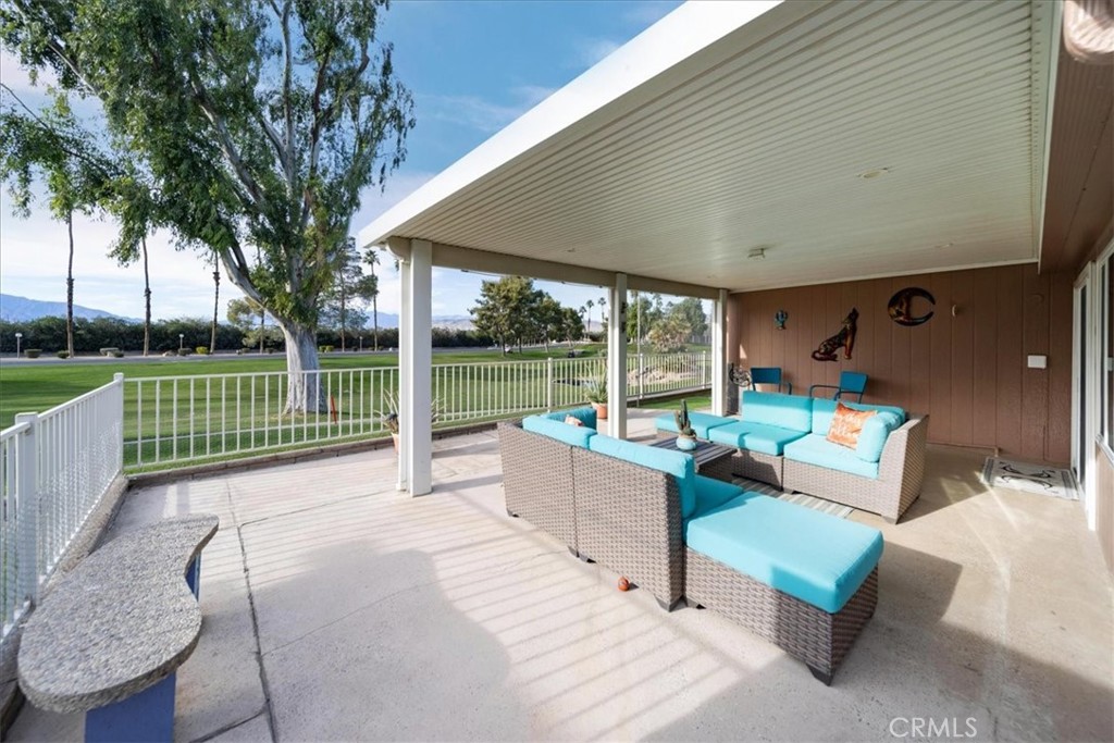 35493 Sand Rock Road Thousand Palms, CA 92276 - Photo 32 of 71 a view of a patio with couches table and chairs and a yard