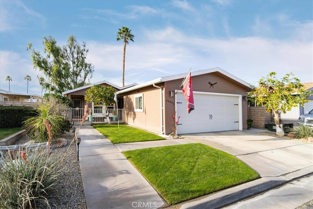 35493 Sand Rock Road Thousand Palms, CA 92276 - Photo 37 of 71 a front view of a house with a yard and a porch
