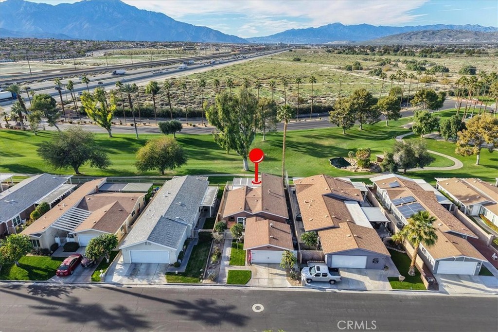 35493 Sand Rock Road Thousand Palms, CA 92276 - Photo 56 of 71 an aerial view of residential houses with outdoor space and parking