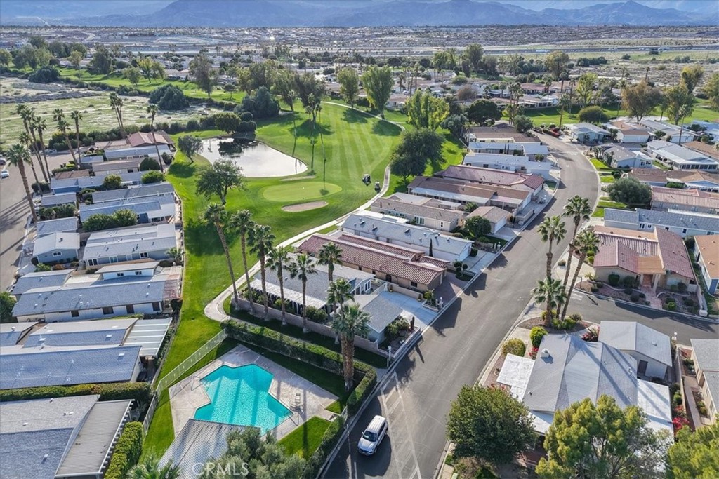 35493 Sand Rock Road Thousand Palms, CA 92276 - Photo 66 of 69 an aerial view of a city with lots of residential buildings and mountain view in back