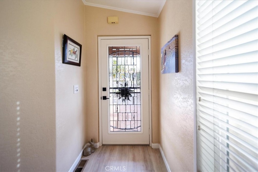 35493 Sand Rock Road Thousand Palms, CA 92276 - Photo 10 of 71 a view of a hallway with wooden floor and windows