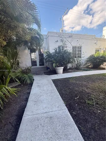 a view of a yard and front view of a house