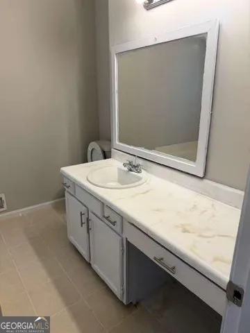 a bathroom with a sink a mirror and a vanity