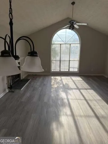 a view of a livingroom with a dishwasher and wooden floor