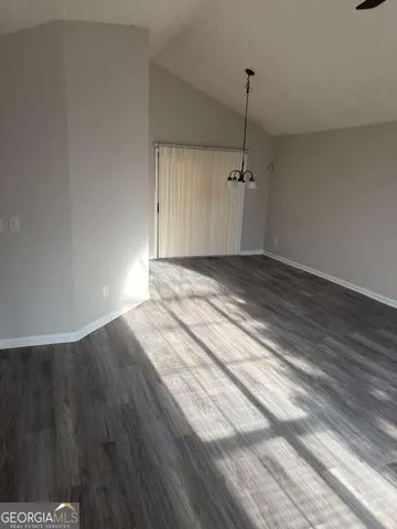 a view of a room with wooden floor and window