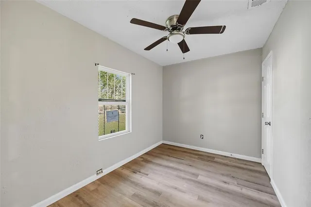 a view of room with window and ceiling fan