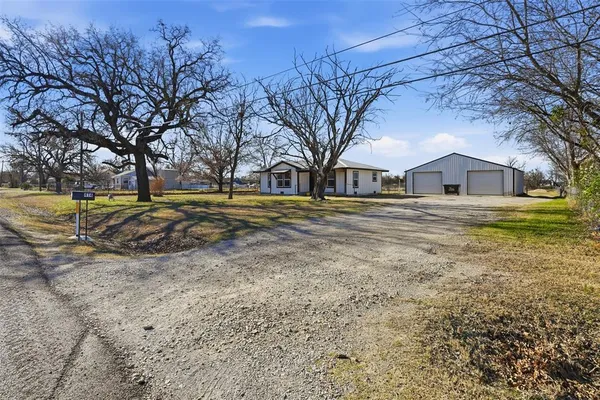 a big house with a big yard and large trees