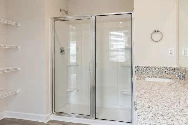 a bathroom with a glass shower door