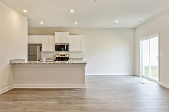 a view of kitchen with microwave and window